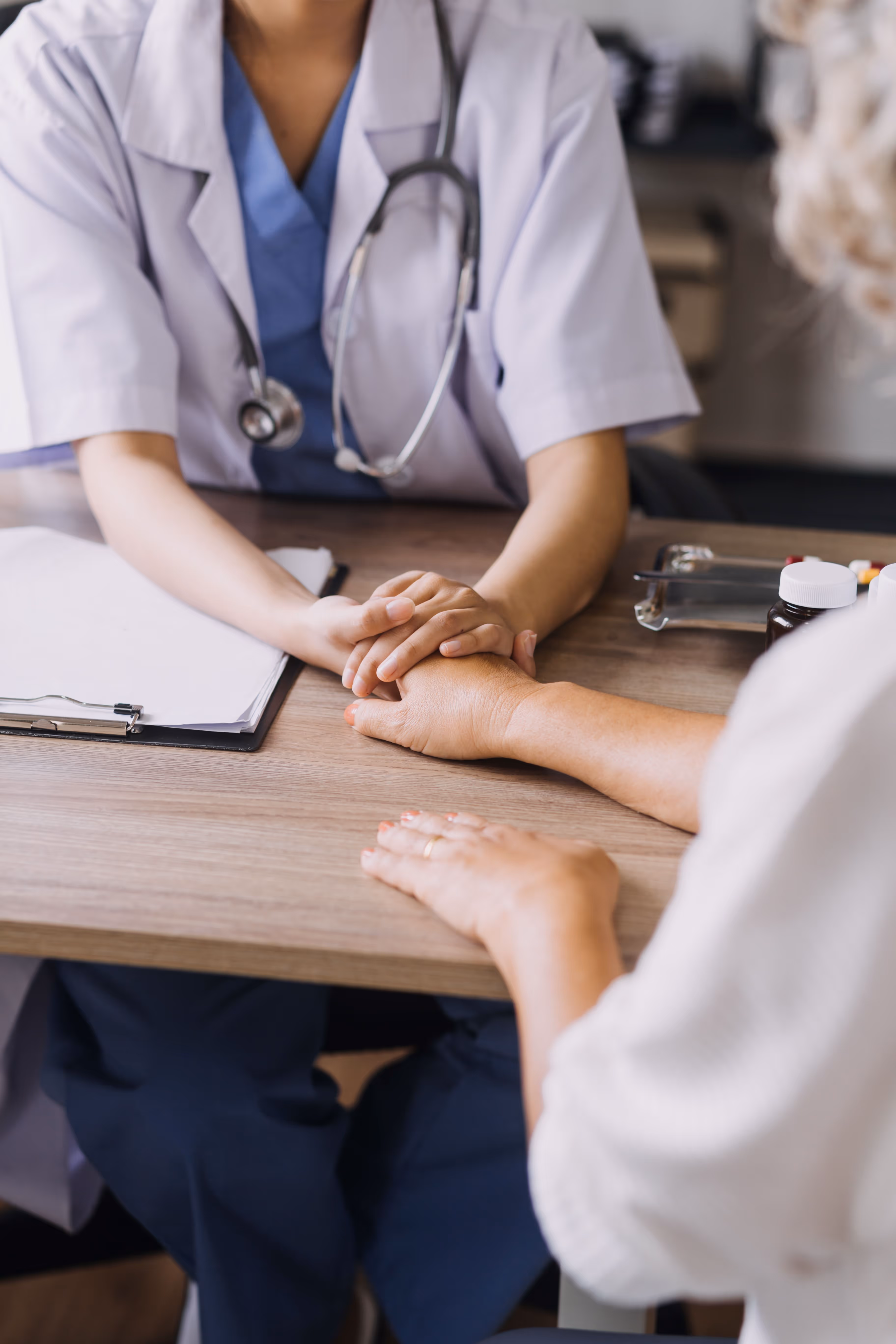 A nurse sitting at a table with a patient.