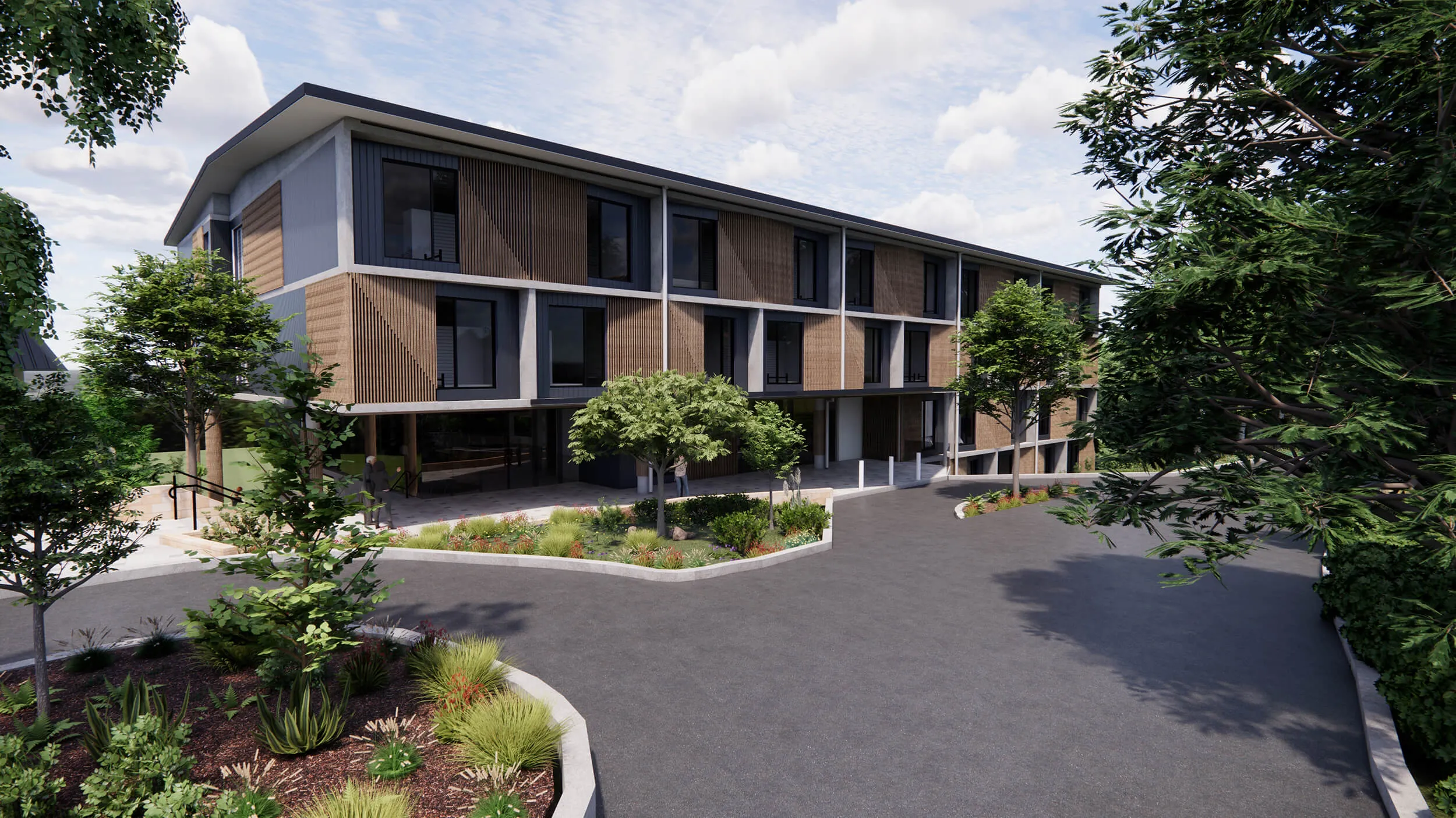 Modern three-story building with wood paneling, surrounded by landscaped garden beds and trees under a partly cloudy sky.