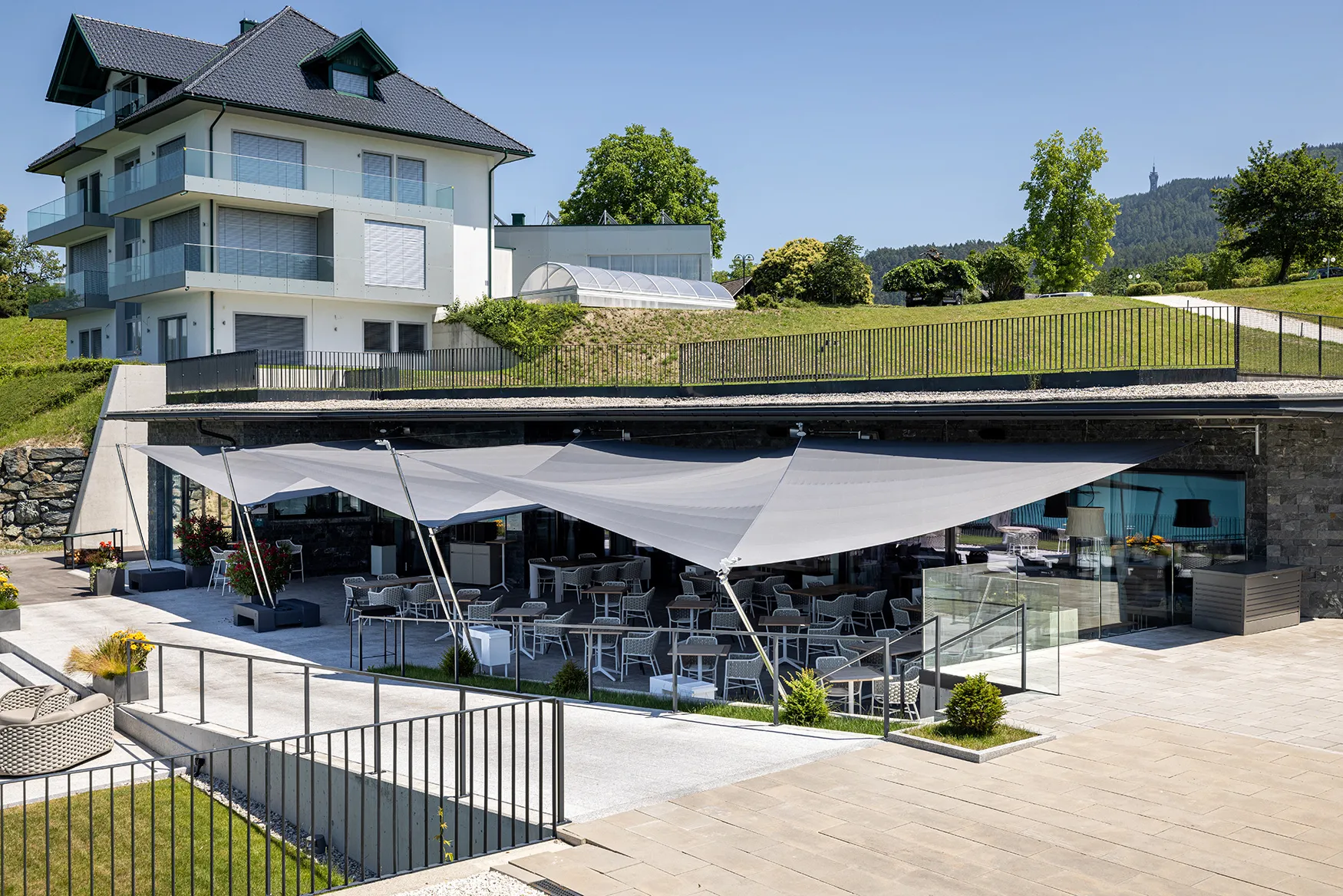 SunSquare Sonnensegel in der gehobenen Gastronomie am schönen Wörthersee. Das Gourmetrestaurant vertraut auf eine dreifach SunSquare-Anlage mit rund 150 m² Tuchfläche, die vor Sonne und Regen schützen.