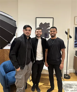 A group of men standing next to each other in a living room.