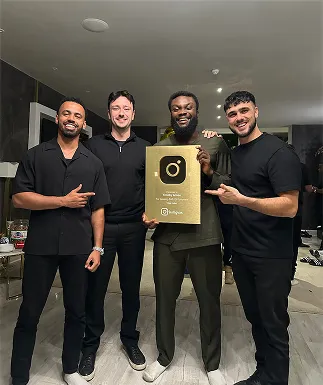 A group of men standing next to each other holding a plaque.