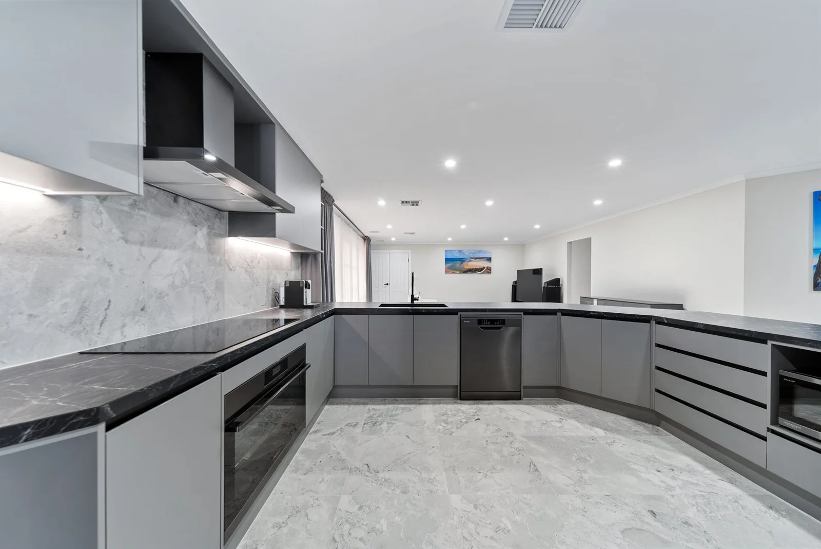 Renovated kitchen with dark benchtops and grey cabinetry in a Craigburn Farm home