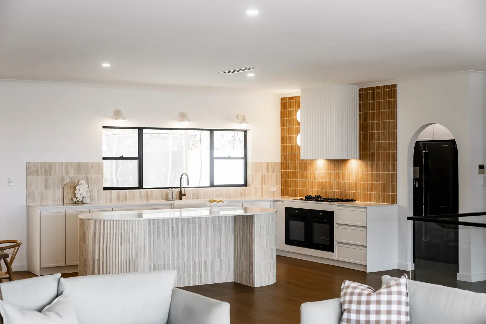 Open-plan kitchen and living area with a curved island, tiled splashback and large window, Jennifer Ave, Bellevue Heights