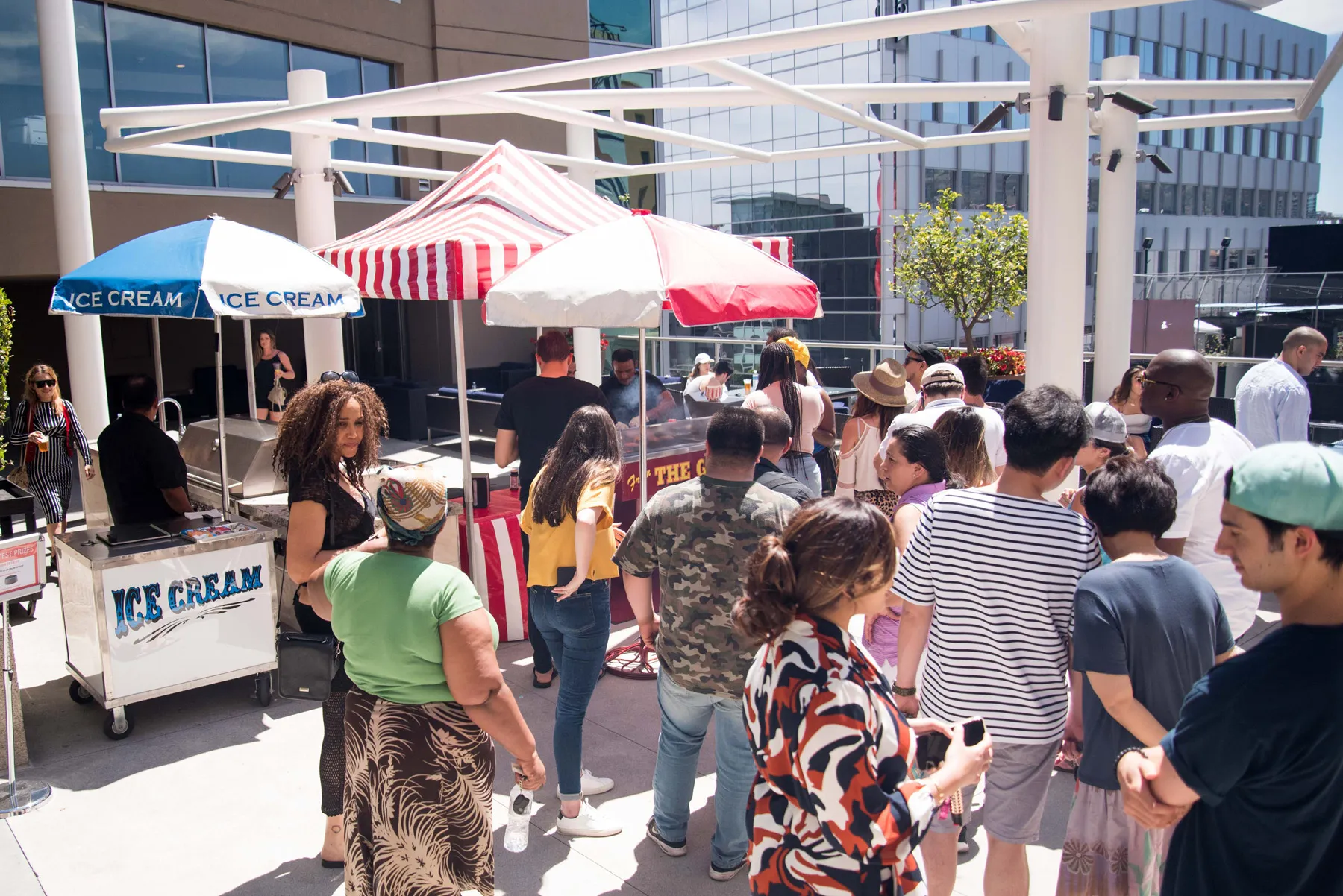 Crowd ordering food from outdoor pop-up stall.