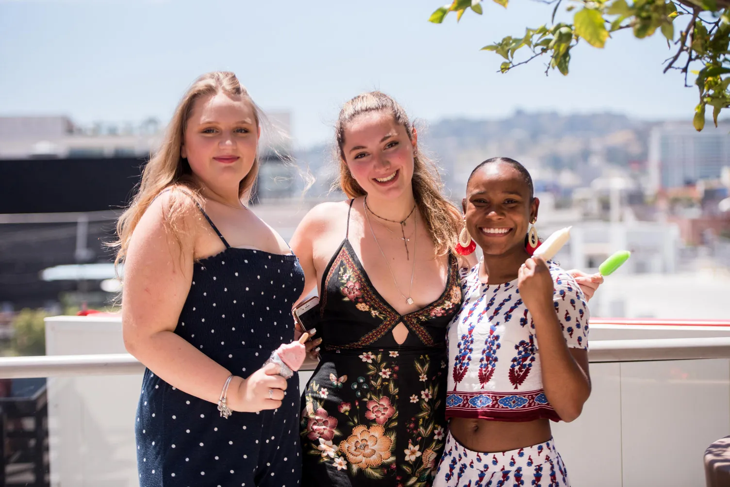 Group of people posing arm in arm for a photo.