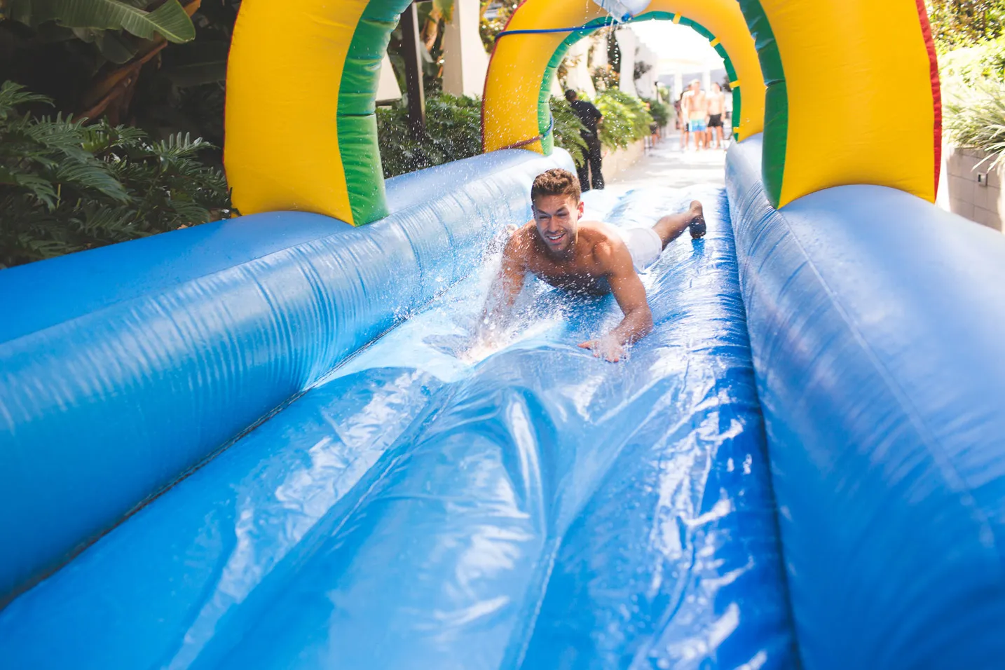 Person sliding down air-inflated water slide.