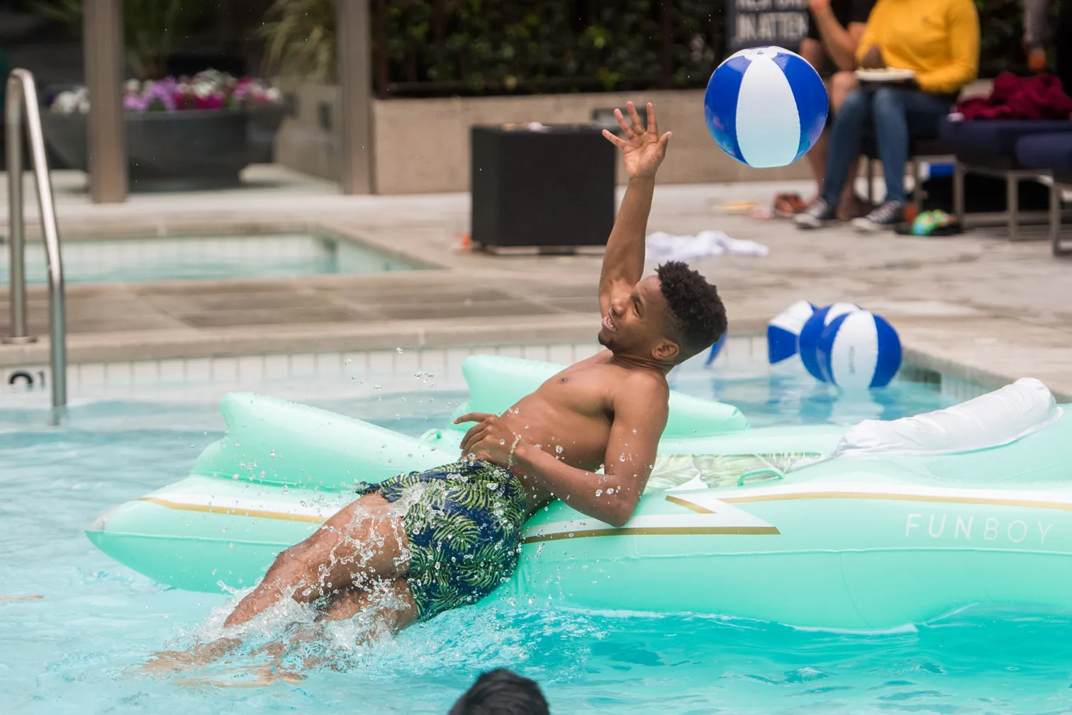Someone lowering into a pool from inflatable toy.