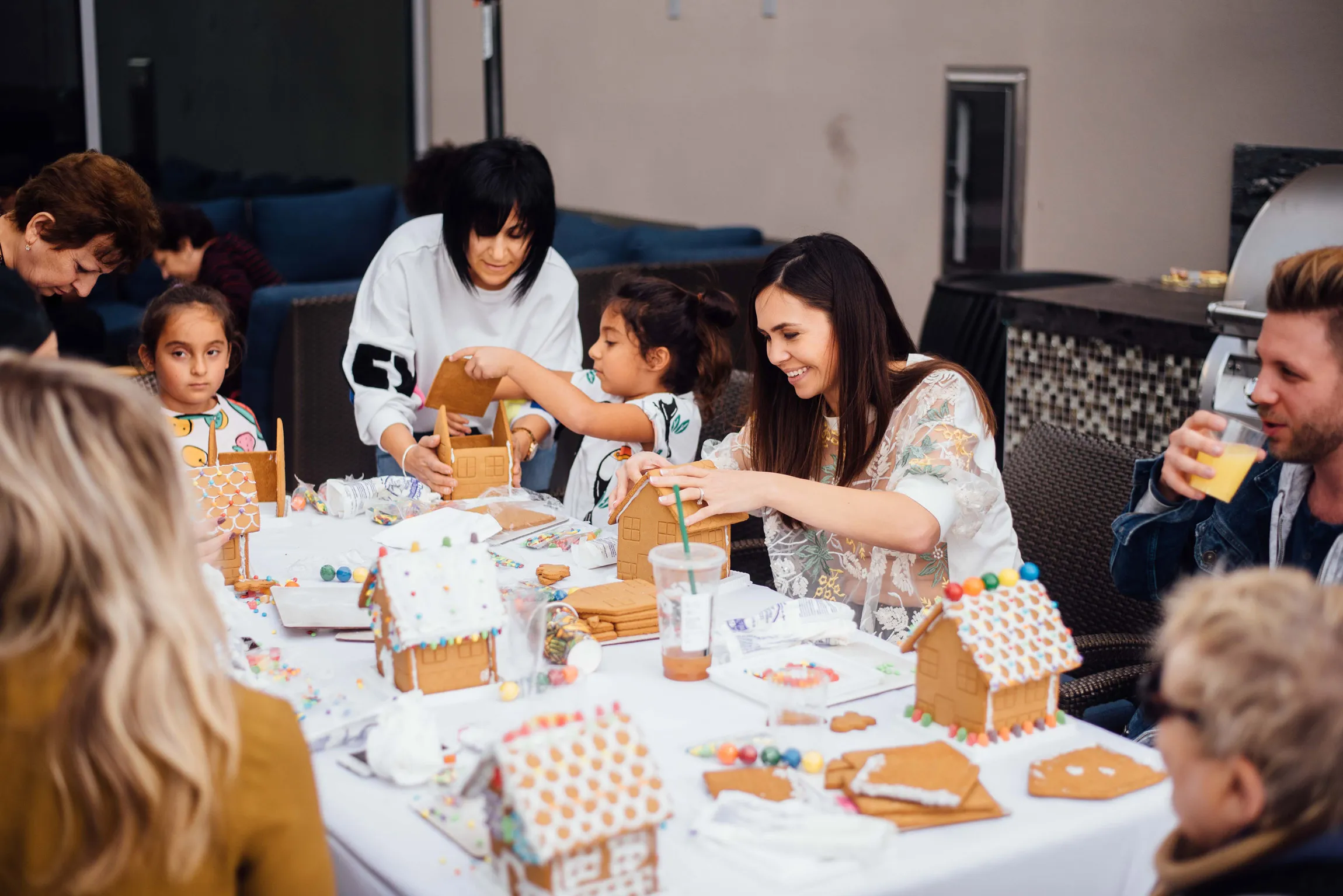 Family event, people building gingerbread houses