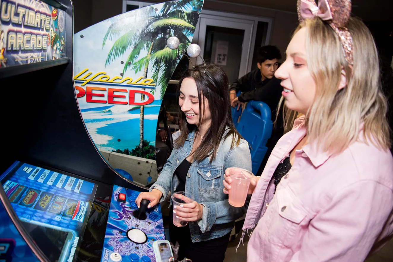 2 girls playing arcade games