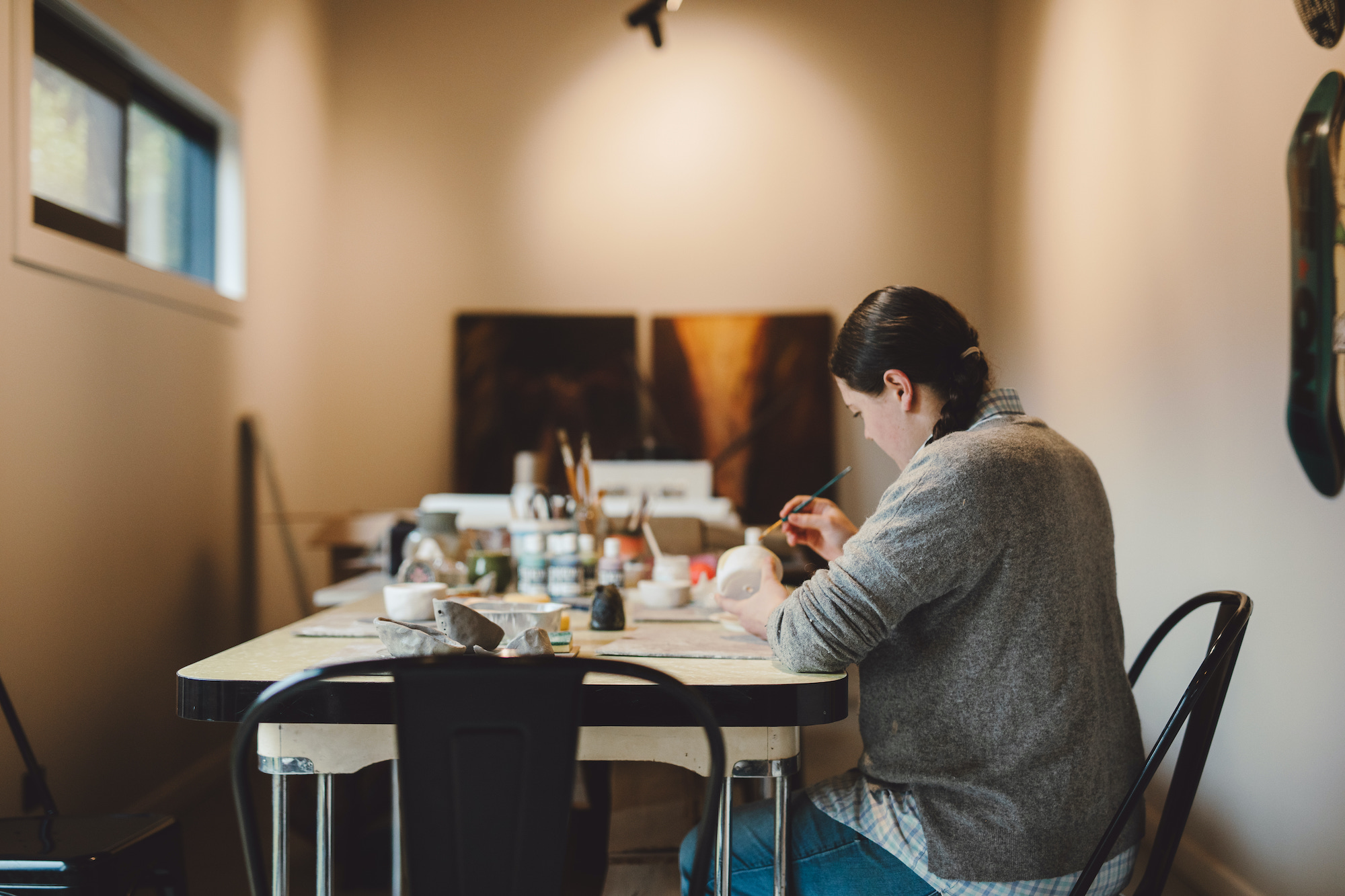 Woman glazing her pottery