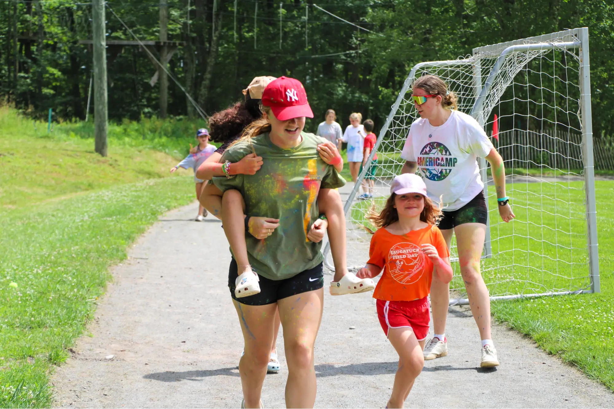 AmeriCamp counsellors and camp participants running on an outdoor path