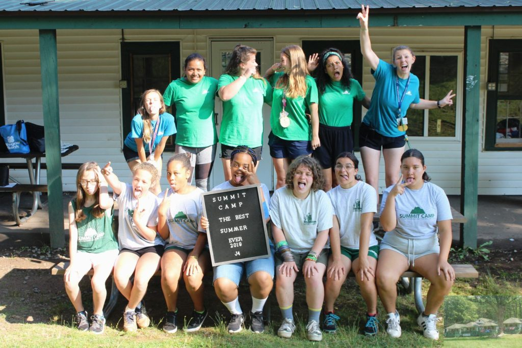 Summit Camp and Travel participants posing for a photo in front of their cabin