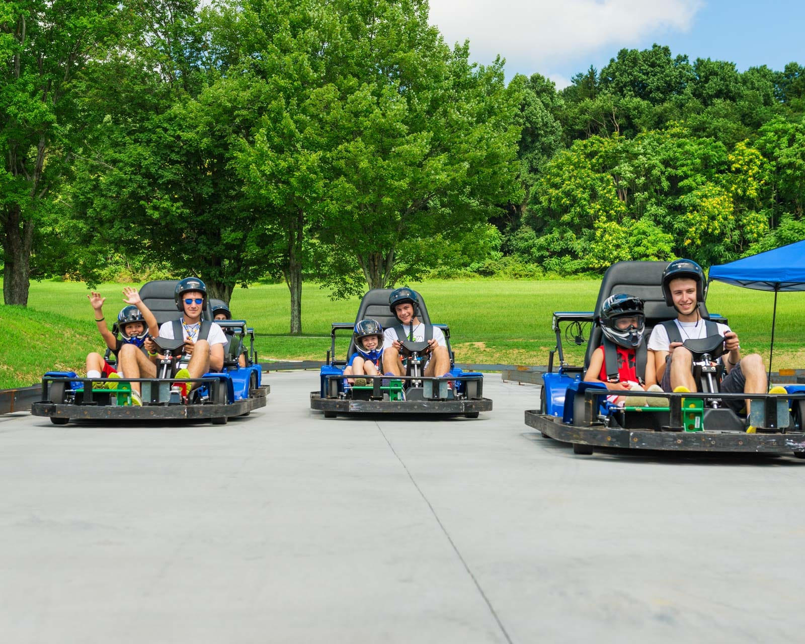 Camp counsellors and campers in go-karts at Camp Airy for Boys