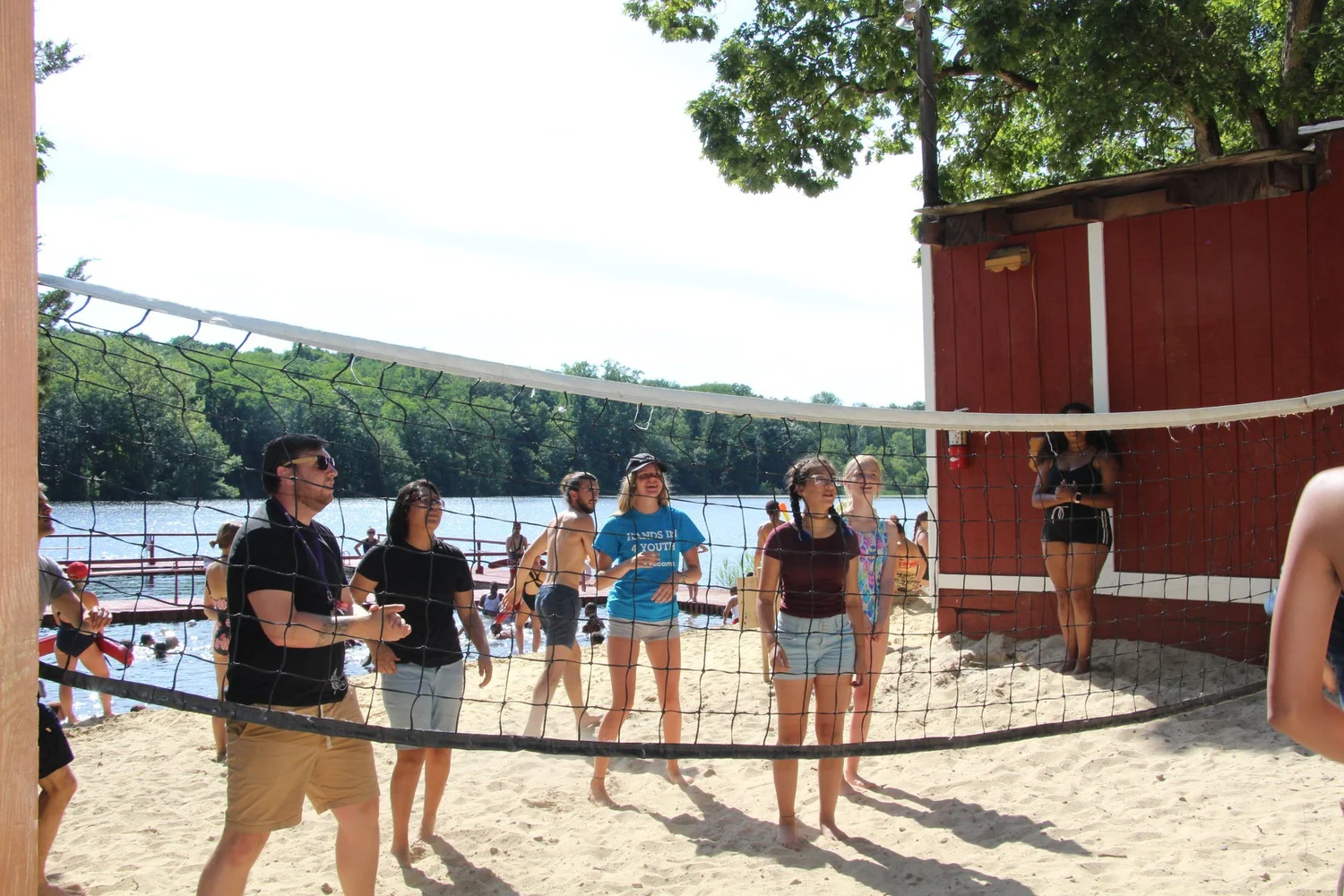 Campers and camp counsellors at Camp Vacamas playing beach volleyball