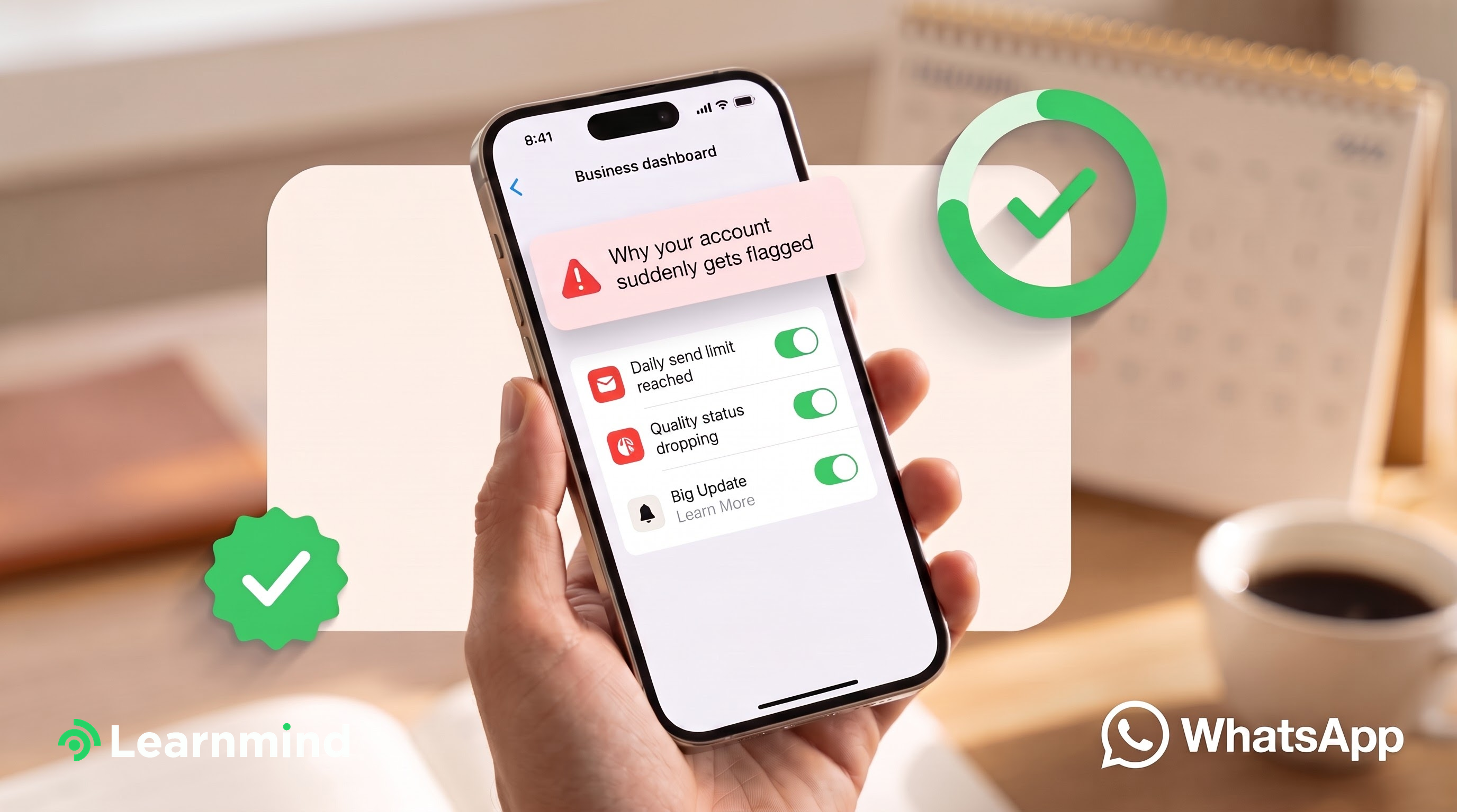 [wa-graphic] Hand holding phone with flagged-account dashboard, green checkmark badges, blurred desk photo background