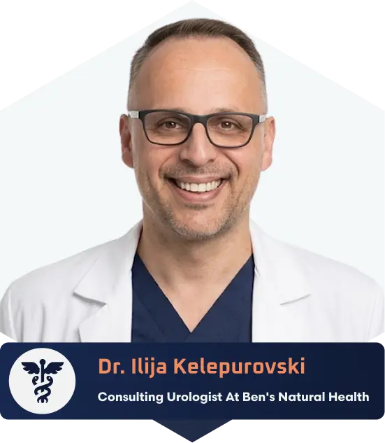 Portrait of Dr. Ilija Kelepurovski wearing glasses, a white coat, and a navy shirt, smiling.