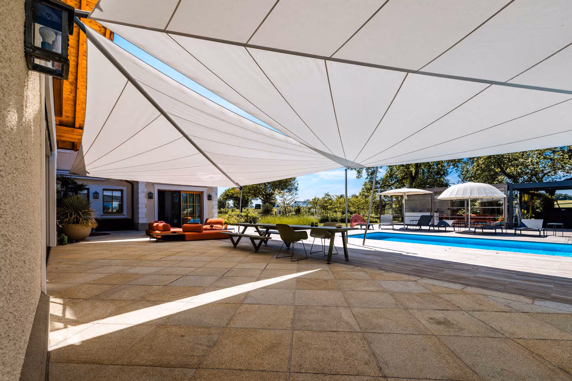 Großflächige Doppel-SunSquare-Anlage schafft stilvollen Schatten im exklusiven Außenbereich.