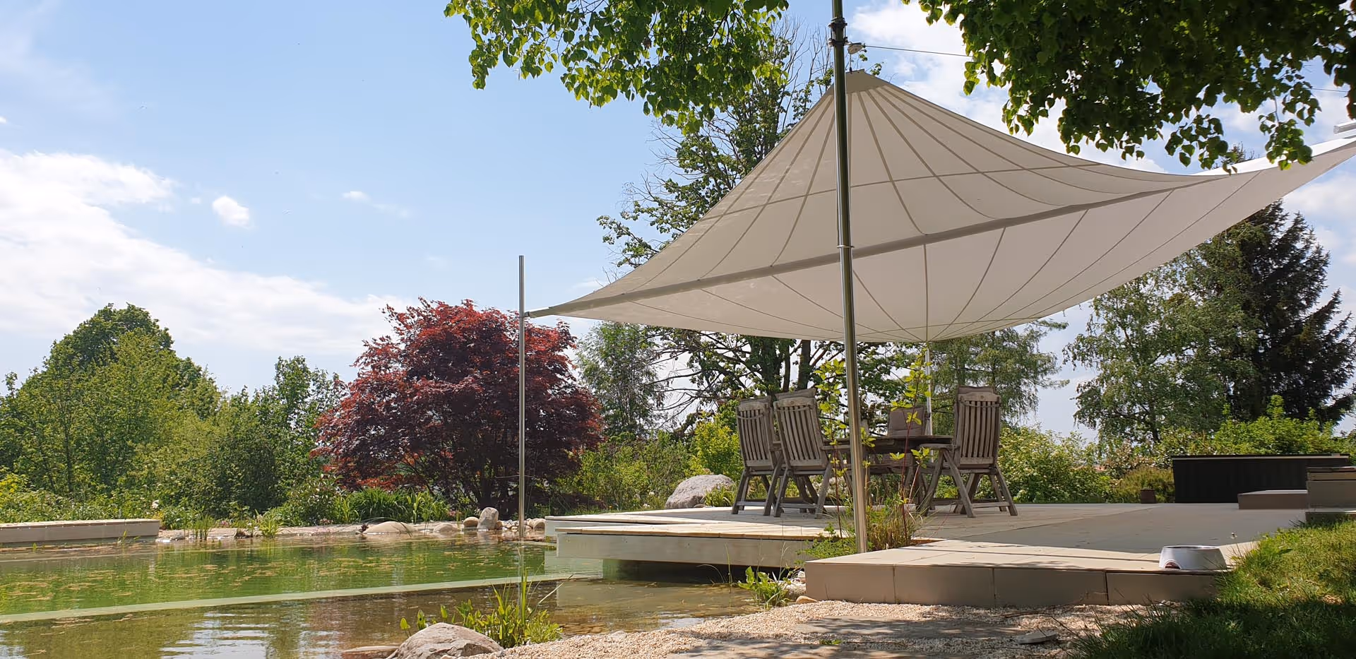 SunSquare awning with F-support in natural swimming pond — 56 m² shade area in natural surroundings