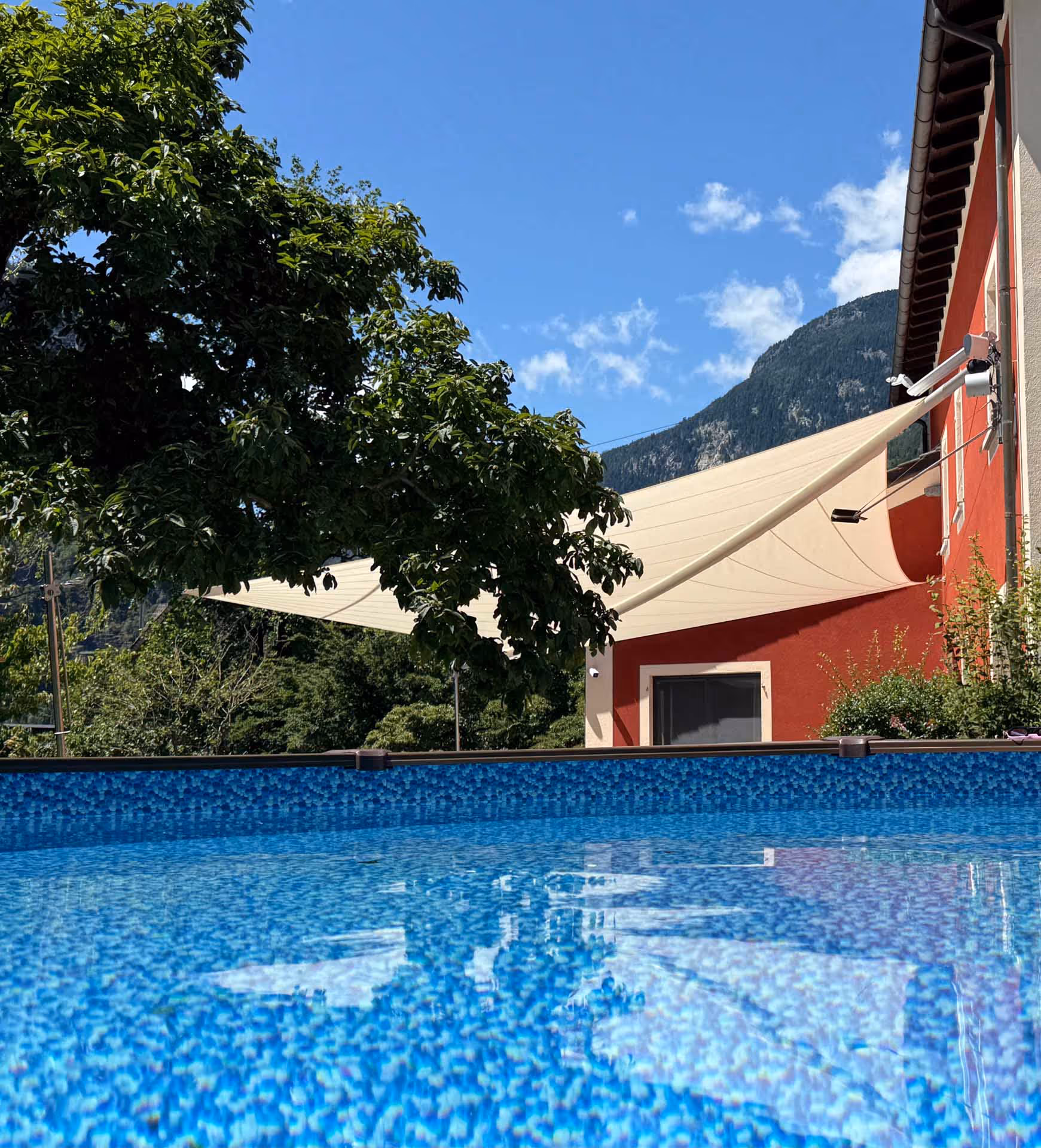 SunSquare radiation sail over terrace with pool — 65 m² sun protection from Koller Tende in Switzerland