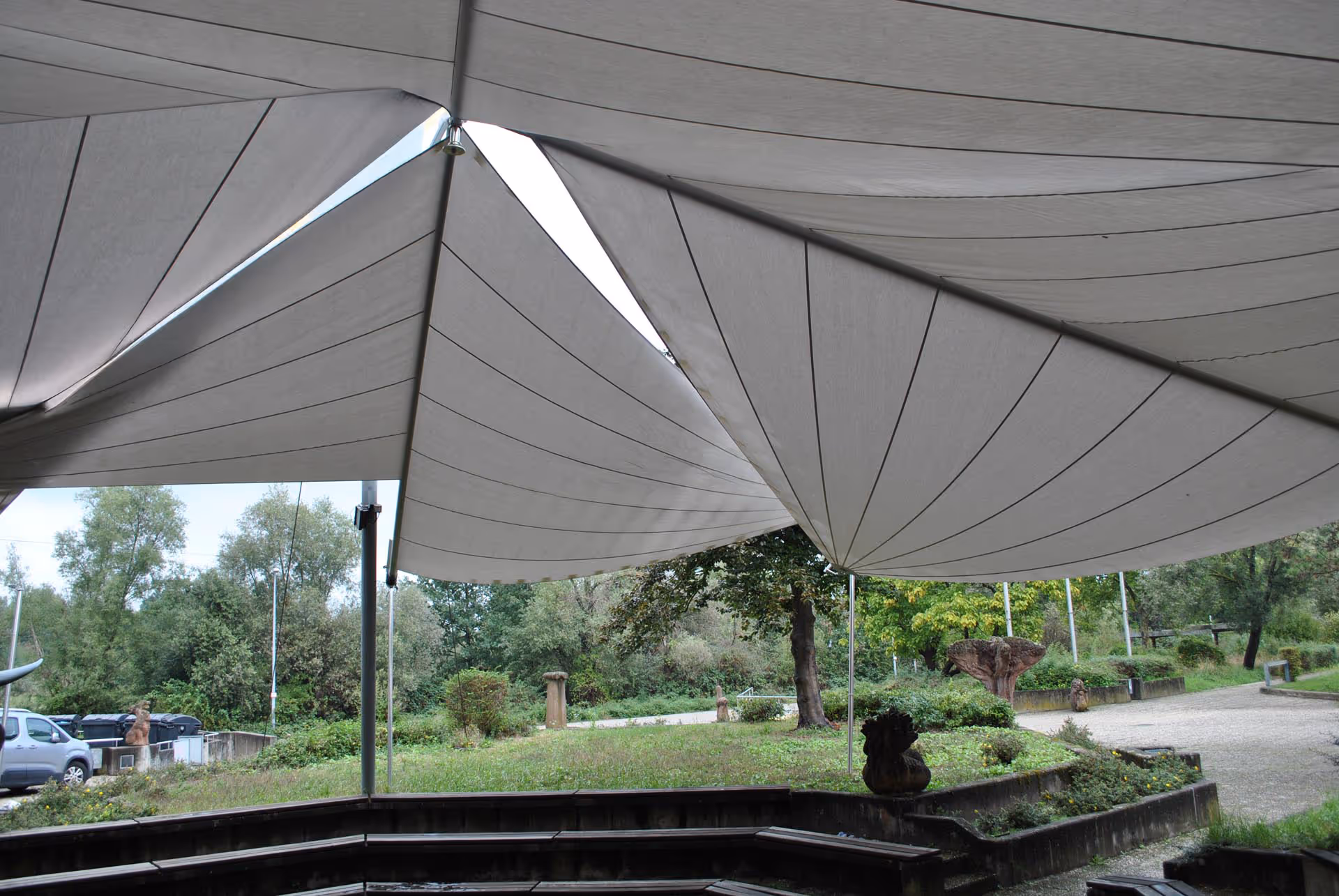 SunSquare Sonnensegel SQK-I mit Stahlwellen über achteckigem Forum eines Gymnasiums – freitragende Konstruktion.