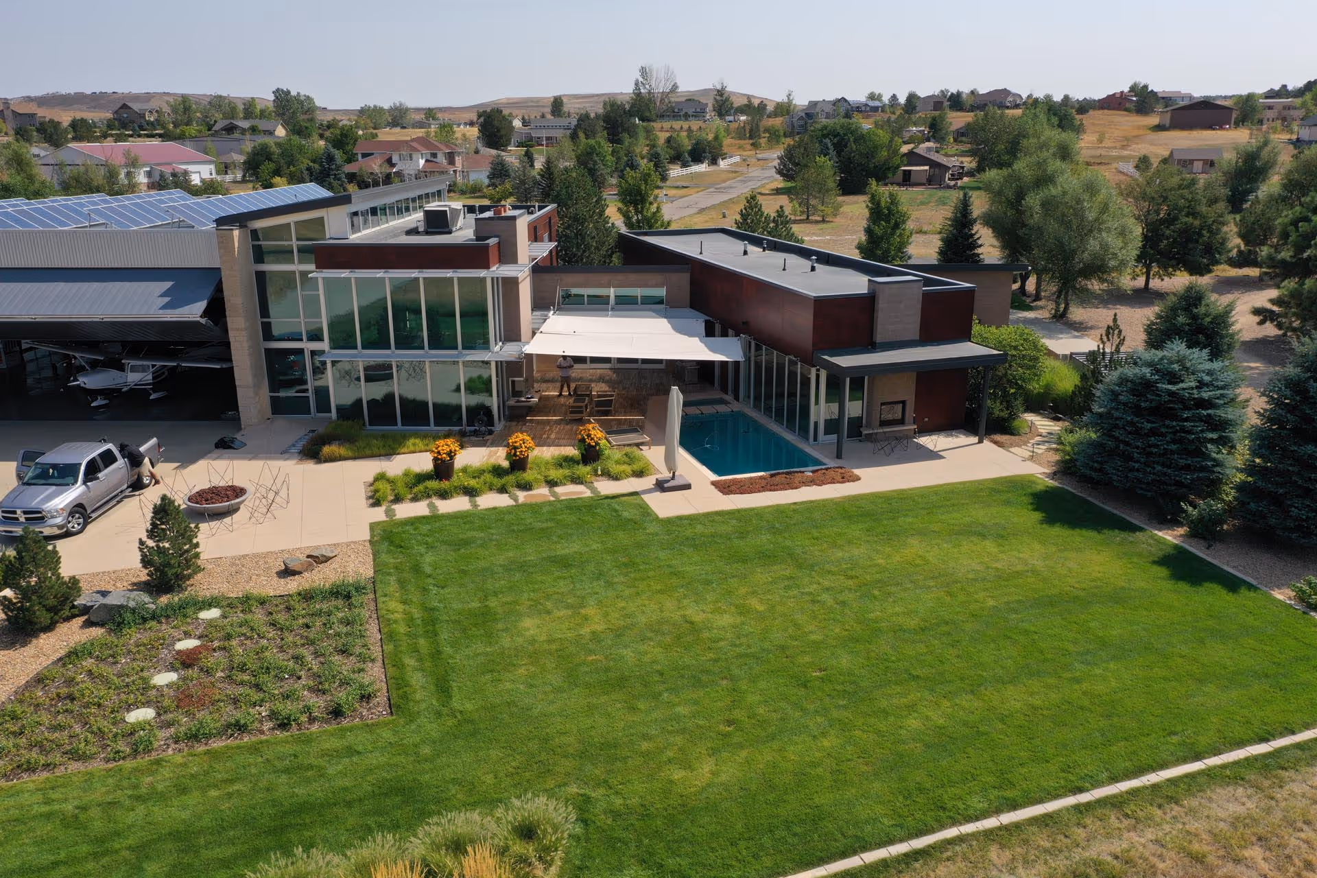 The property photographed from a distance – here you can see a private hangar for a small aircraft on the left-hand side.
