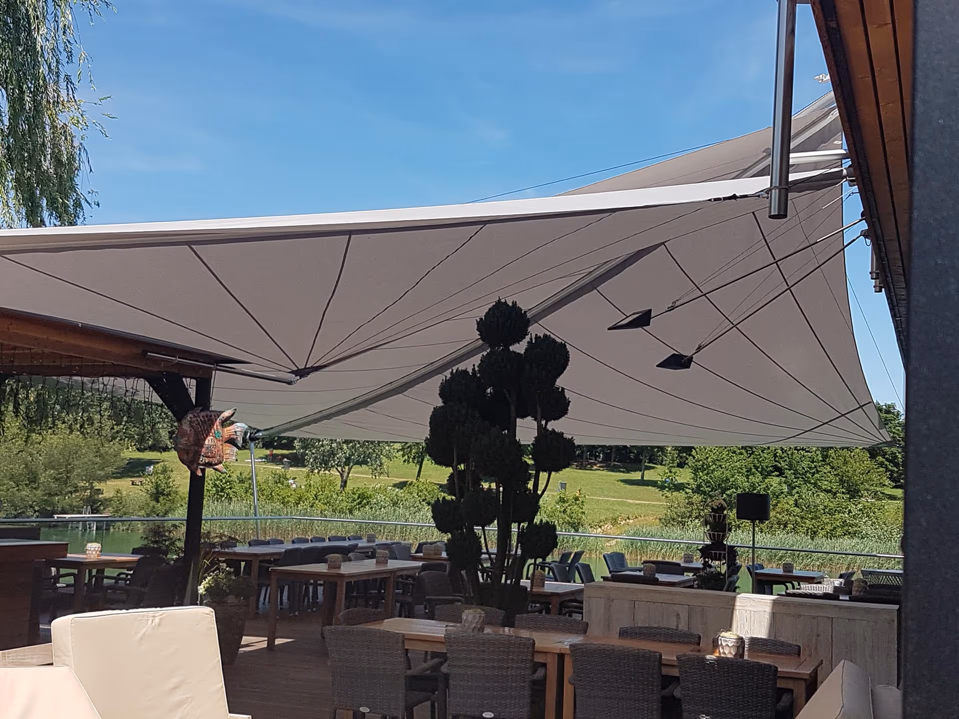 33 m² SunSquare Segel schafft flexible Schattenzonen für Gäste am Wasser.