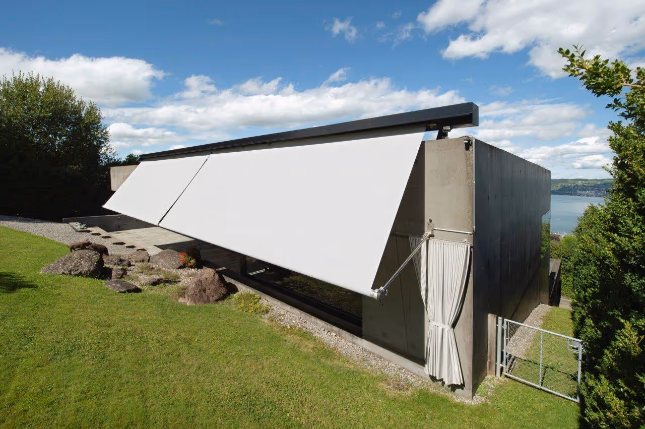 SunSquare drop arm awning integrated into existing metal cladding in the Swiss courtyard