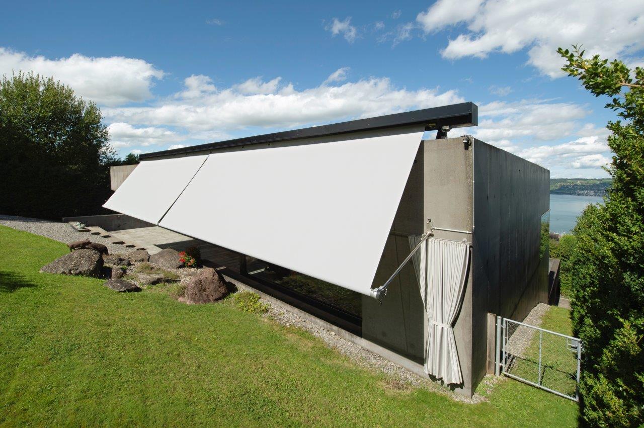 SunSquare drop arm awning integrated into existing metal cladding in the Swiss courtyard