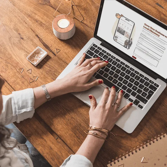 Woman signing up to Love Local Calendars on a Macbook. 