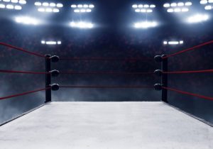 Wrestling ring illuminated by spotlights, symbolizing decision-making momentum and action in leadership contexts.