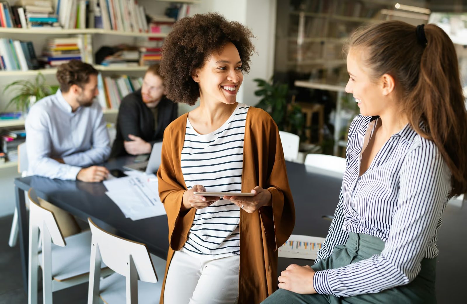 A modern leader having an open, authentic conversation with their team in an office setting