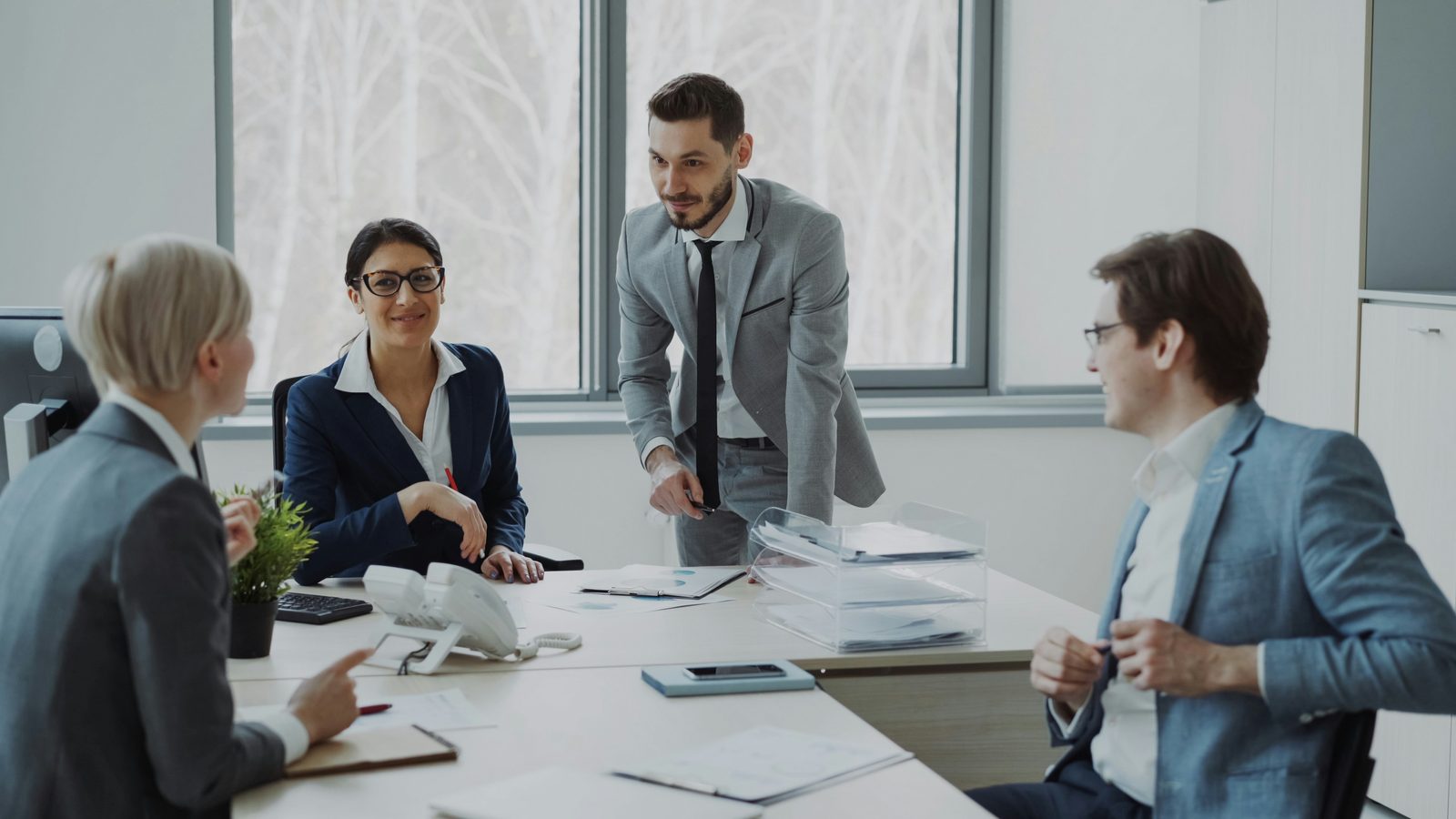 diverse business team collaborating around a conference table solving a problem together