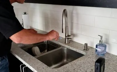 ATP contamination testing swab being used to measure baseline biological contamination levels before electrostatic disinfection treatment