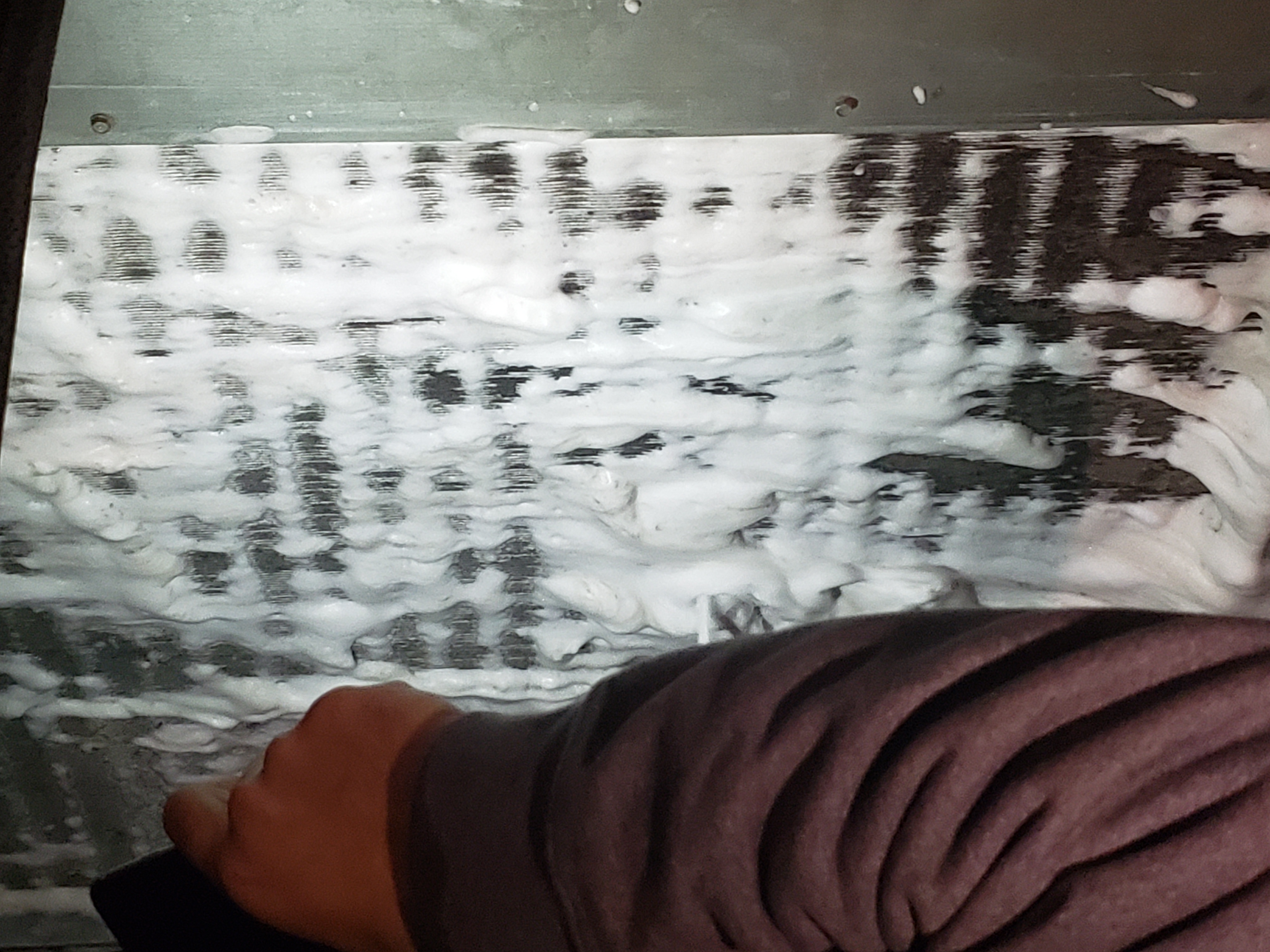 Hail damage to HVAC equipment showing impact on condenser coils