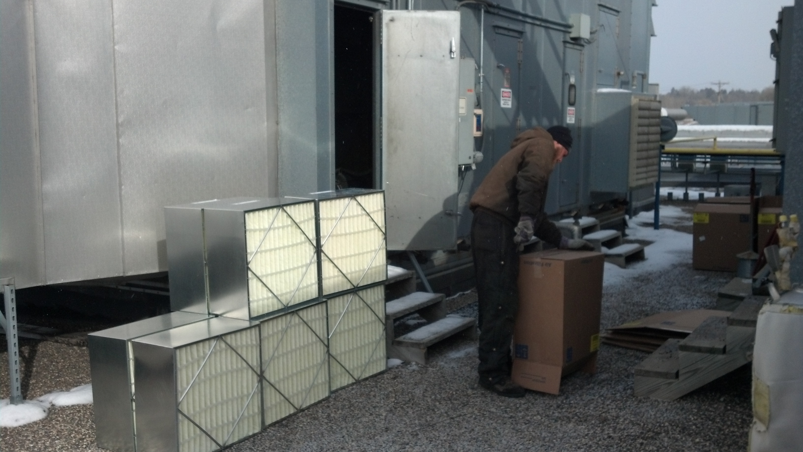 Professional HVAC maintenance team with service van and cleaning equipment