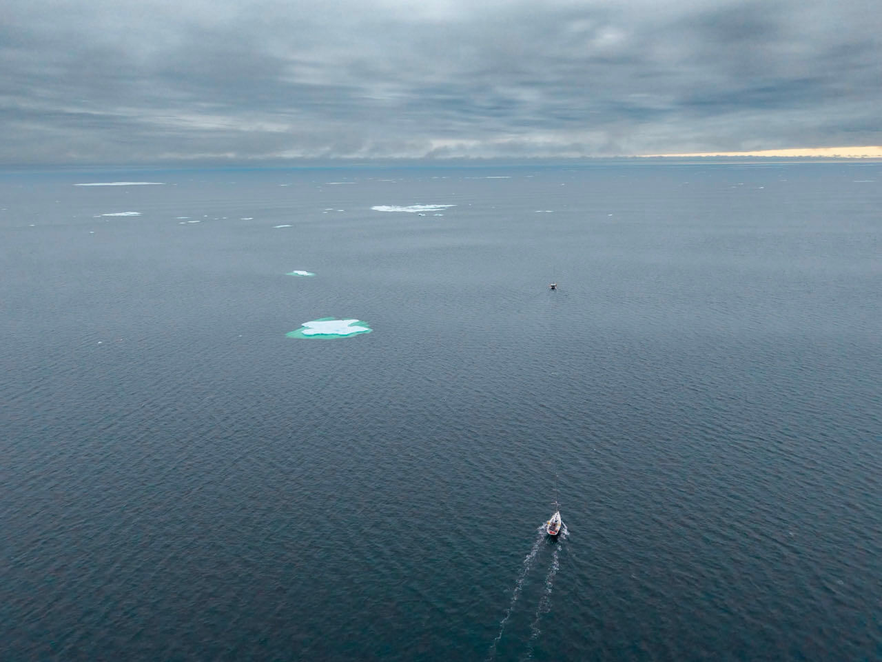 Aerial view of Vanuily sailing past scattered ice in the Canadian Arctic during its Northwest Passage voyage.
