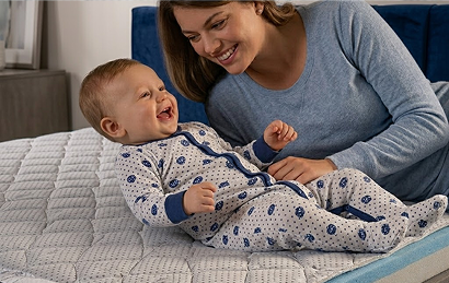 Baby and mother on mattress