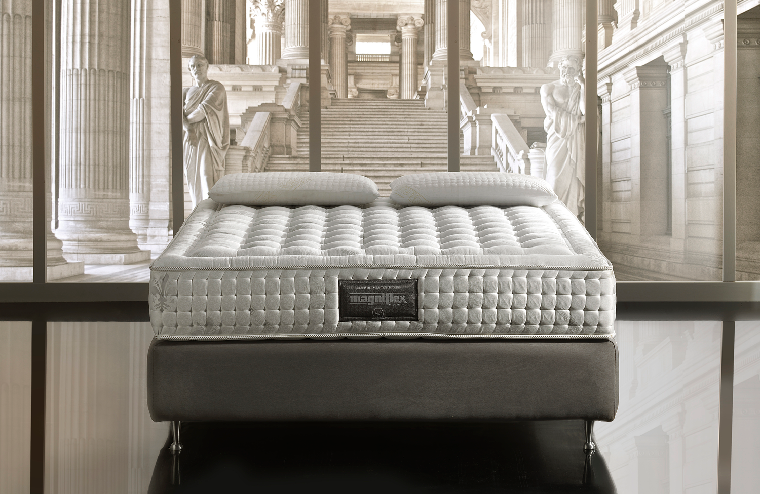 Magniflex premium mattress displayed in a classical architecture setting