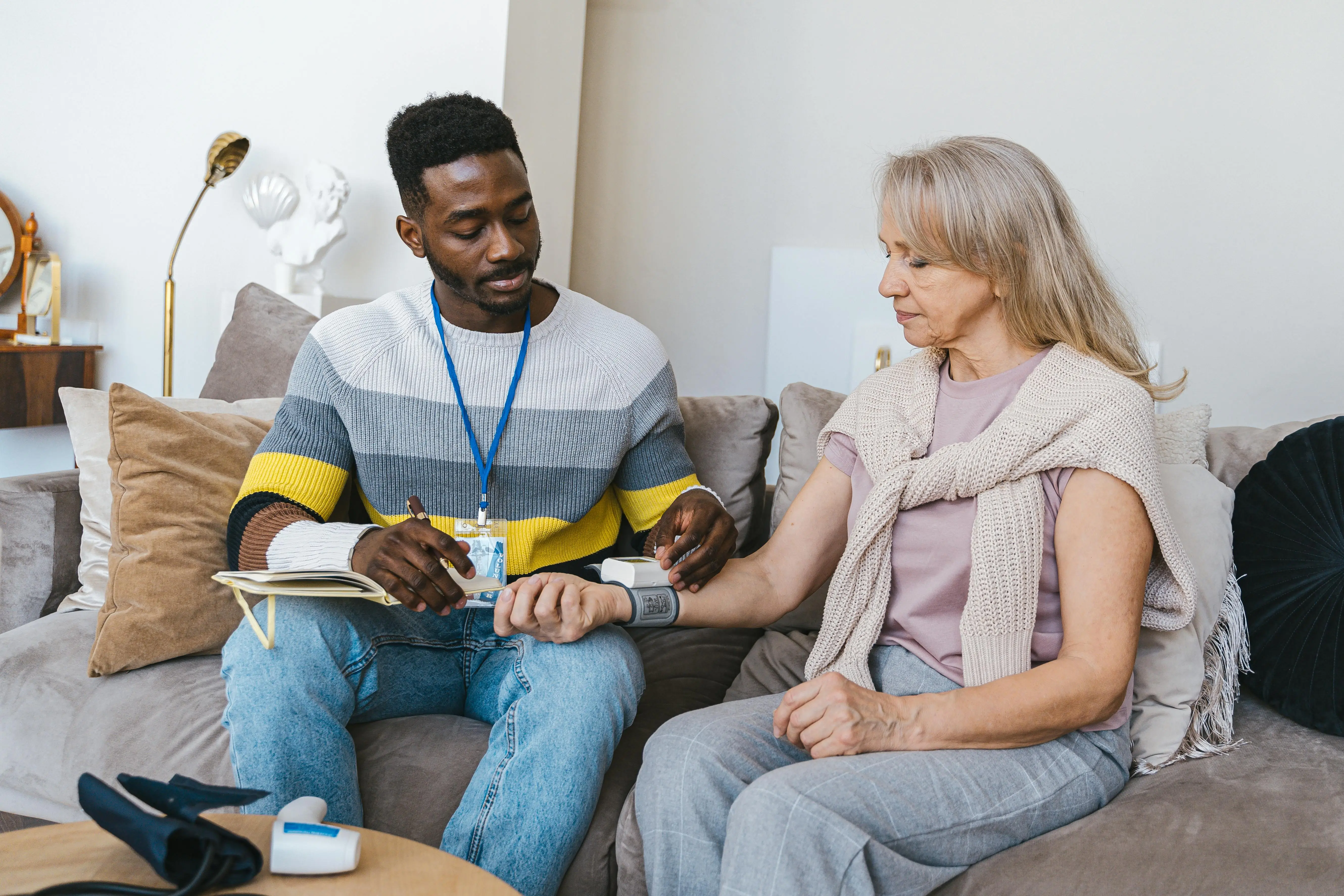 A Haven Oaks care professional performing a daily wellness check for a senior client, defining what compassionate nursing care is.