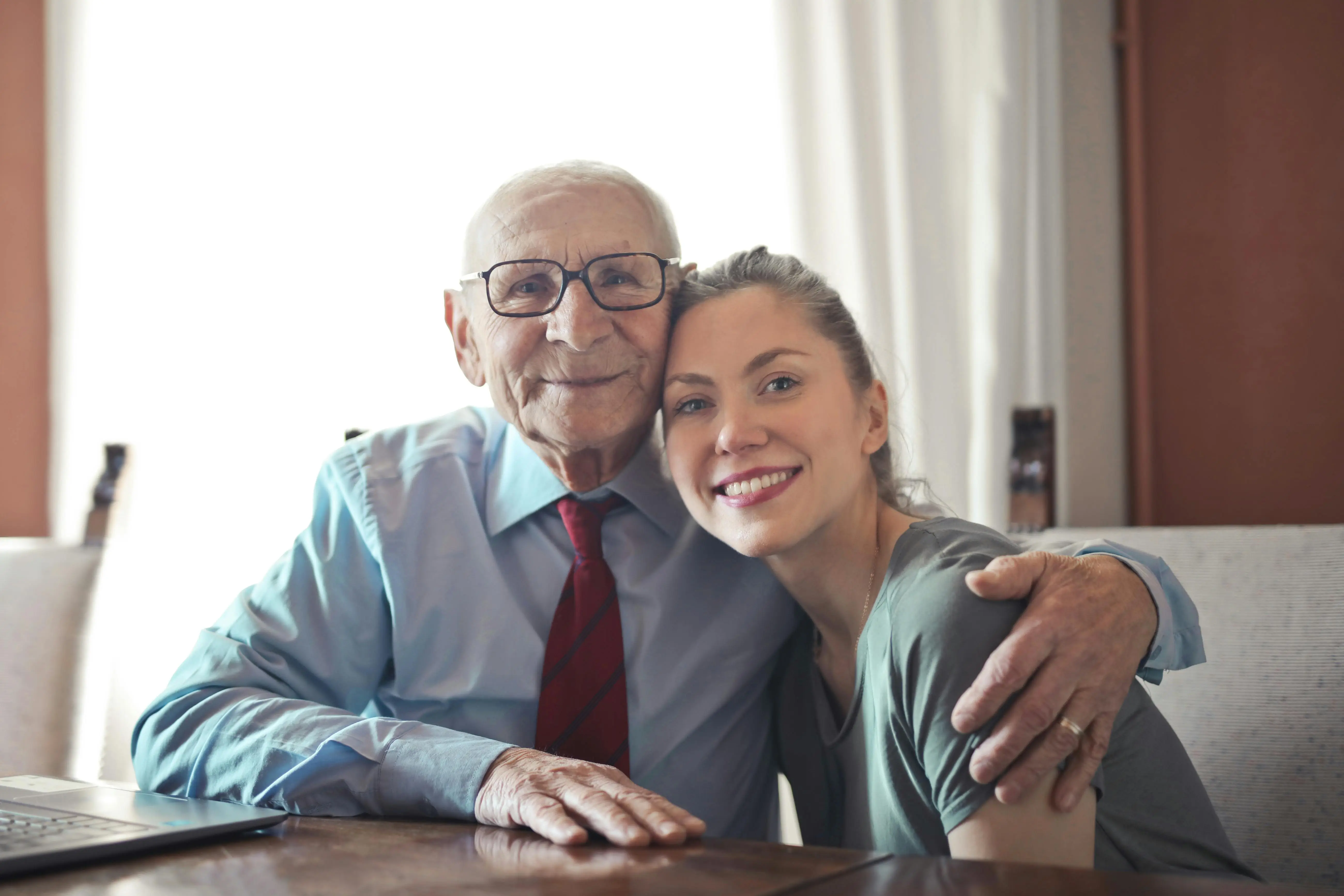 A skilled Haven Oaks nurse provides physical assistance to a senior, representing our expert nursing care services