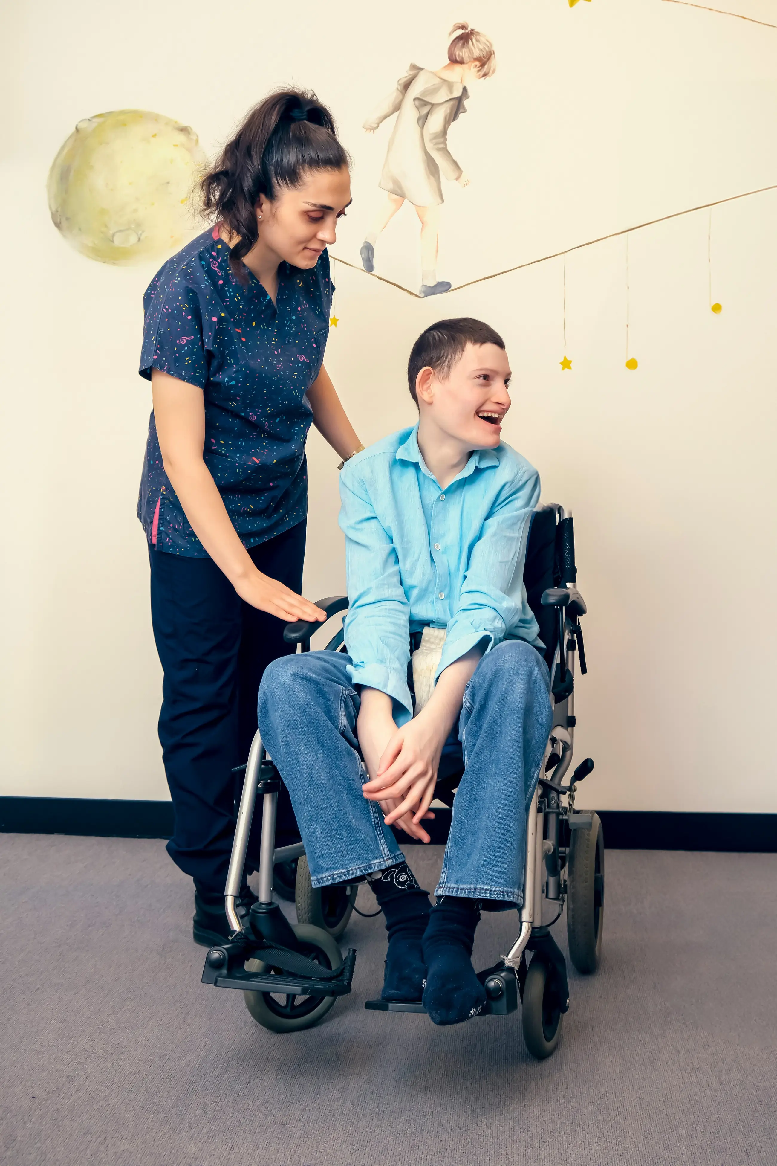 nurse celebrating birthday of a disabled young man in wheelchairs