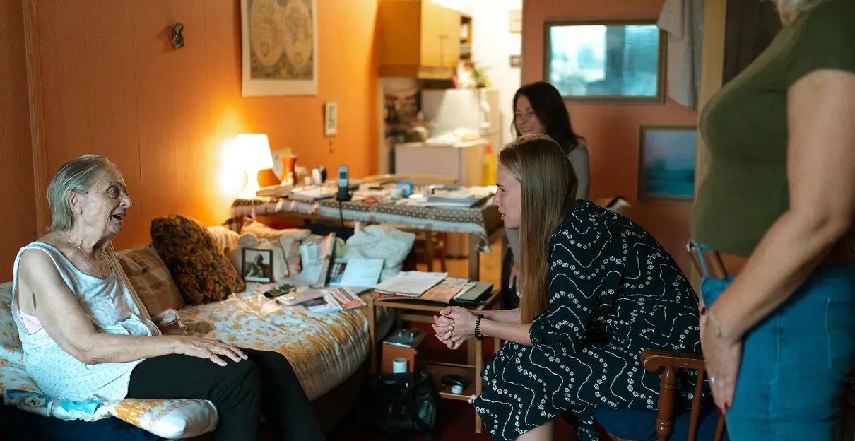 caregiver talking with elderly woman