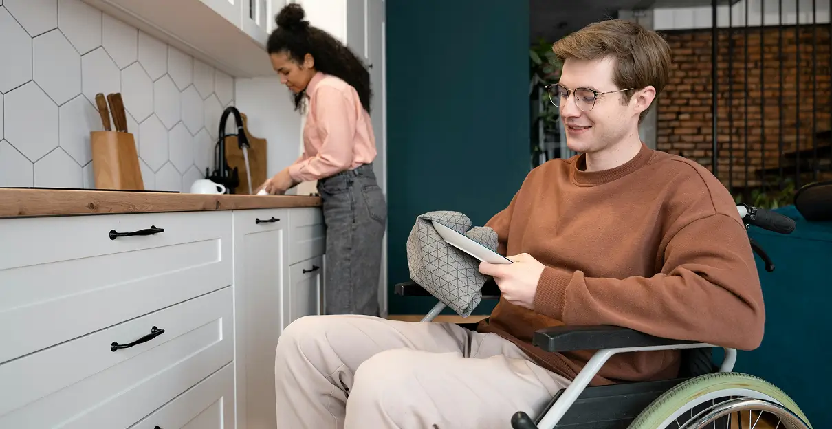 caregiver cooking for young adult on wheelchair