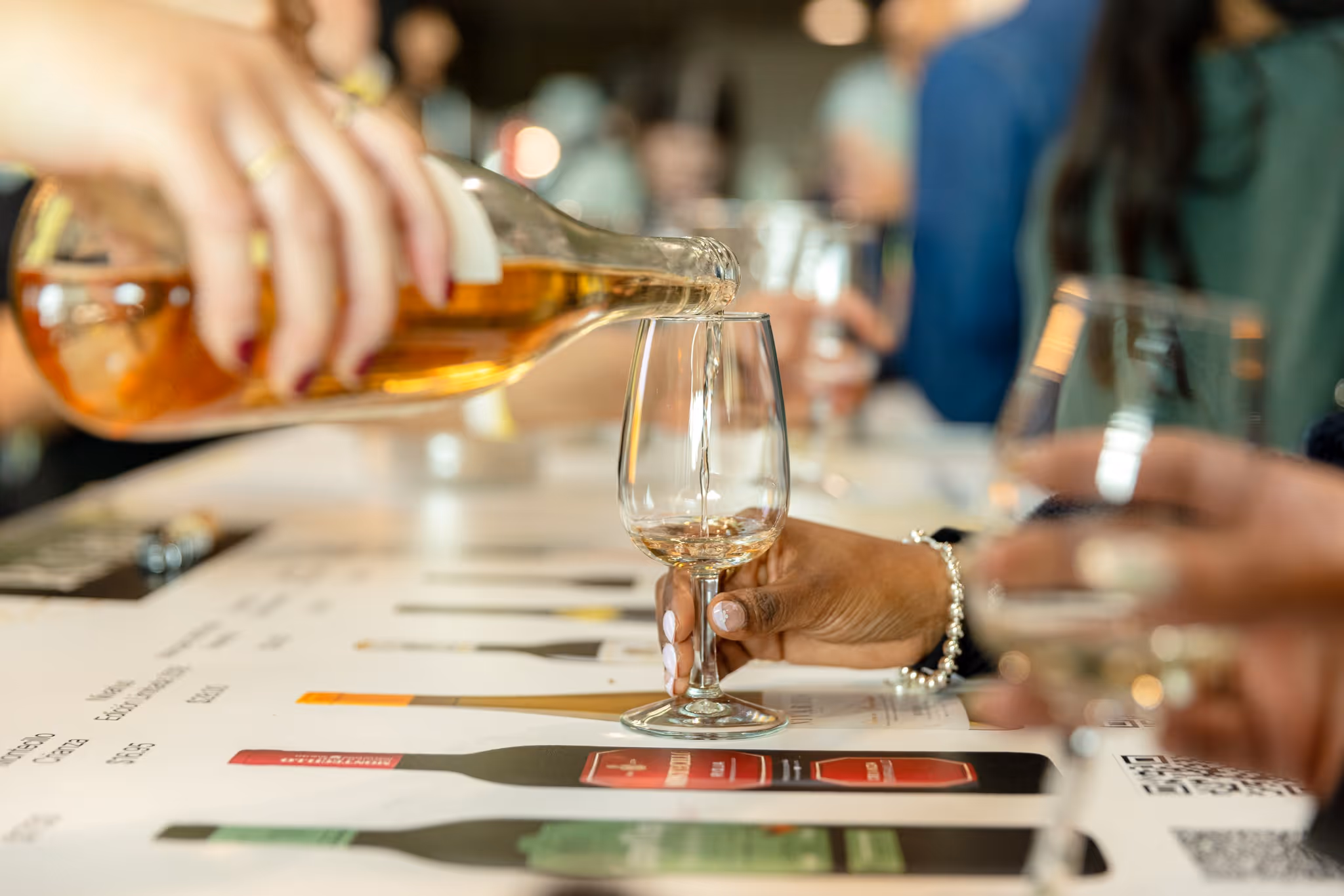 A person pours wine