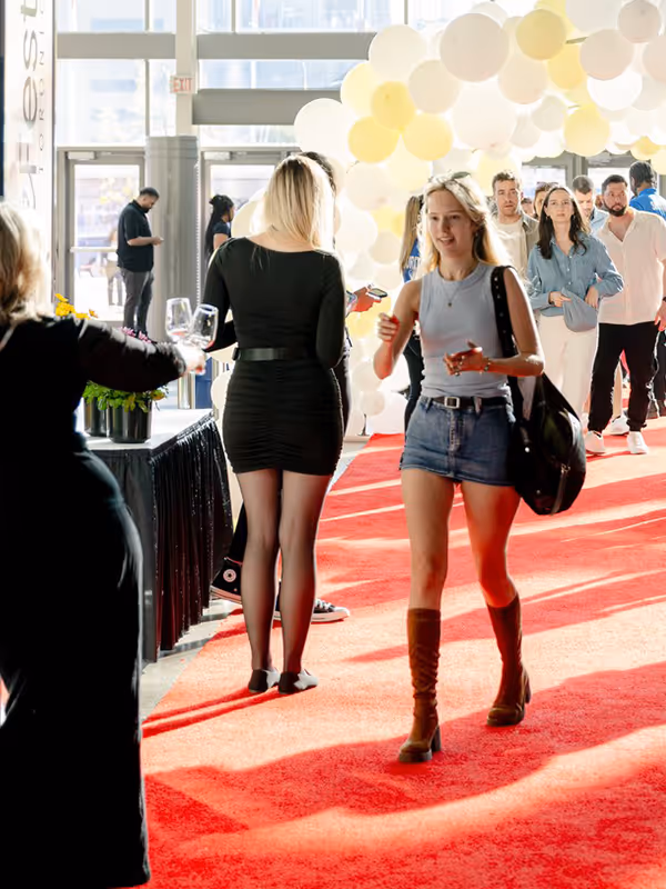 A person walking with a glass at Wine Fest Toronto