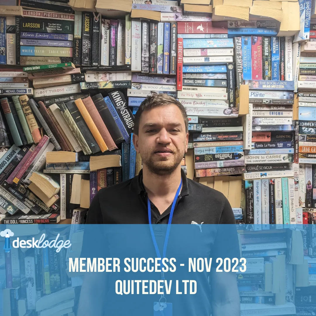 Oleg from QuiteDev Ltd stood in front of the Library wall at DeskLodge House.