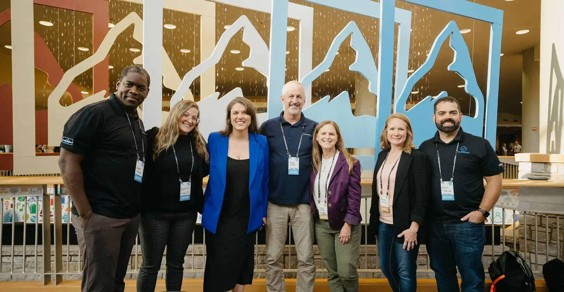 Group smiling and posing in front of Global Leadership Network logos