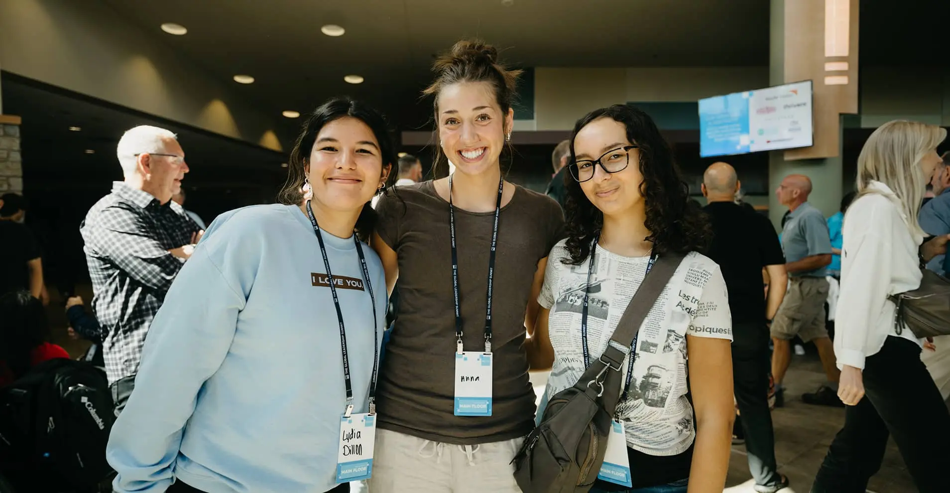 3 women smiling and posing in well lit room
