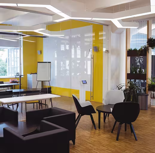 Open office area with yellow wall and white doors