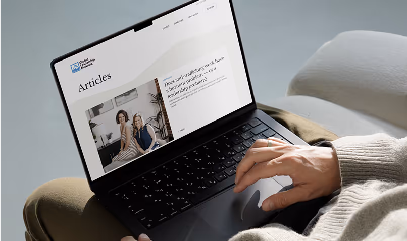 Man with ring on browsing articles page on Global Leadership Network website.
